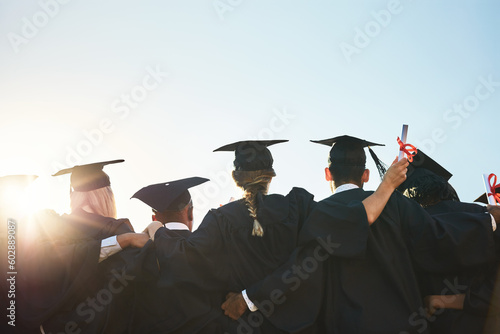 Group, students and graduation for college or university friends together with blue sky mockup. Men and women outdoor to celebrate education achievement, success and future at event for graduates