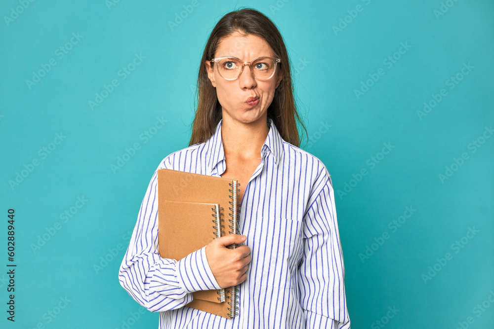 A young caucasian secretary woman isolated confused, feels doubtful and unsure. A young caucasian secretary woman isolated confused, feels doubtful and unsure.