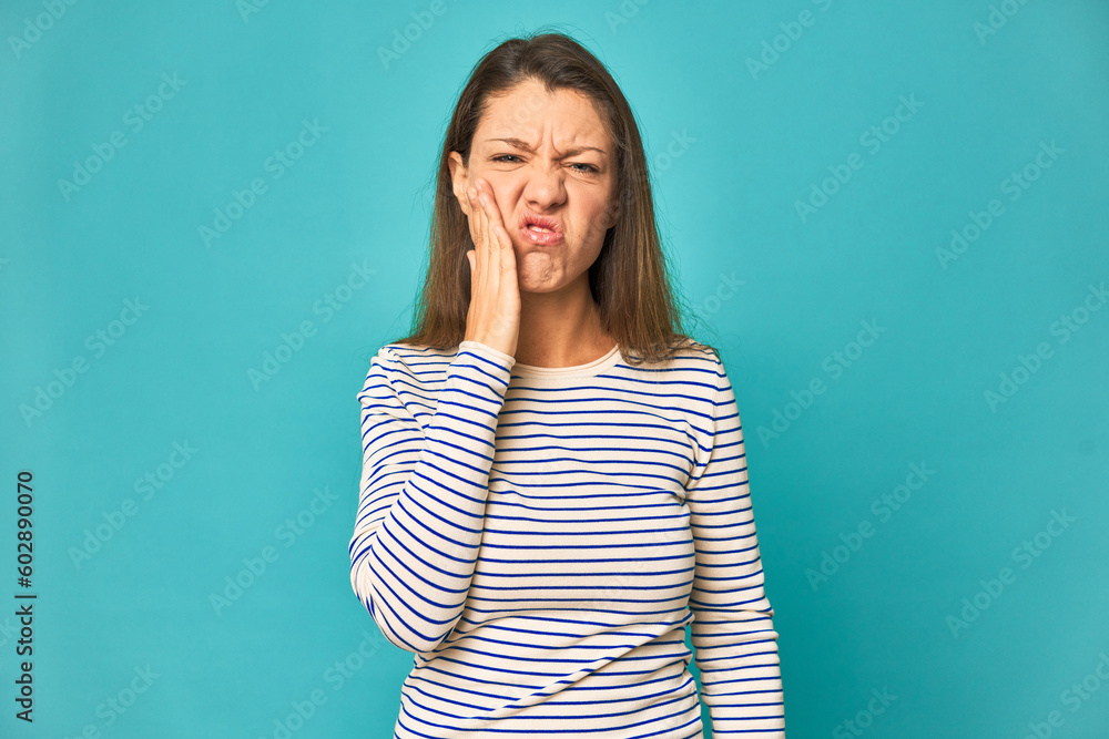 A young caucasian woman isolated having a strong teeth pain, molar ache. A young caucasian woman isolated having a strong teeth pain, molar ache.