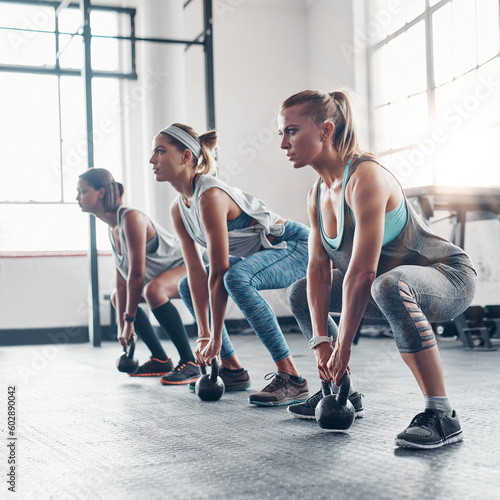 Group, exercise and women training, kettlebell and workout goal with wellness, healthy lifestyle and sports. Female athletes, girls and friends with gym equipment, balance and stretching for cardio