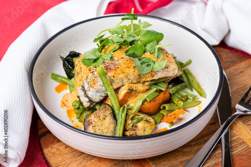 Grilled Barramundi with roast vegetables and creamy sauce