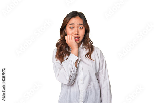 A young chinese woman biting fingernails, nervous and very anxious. photo