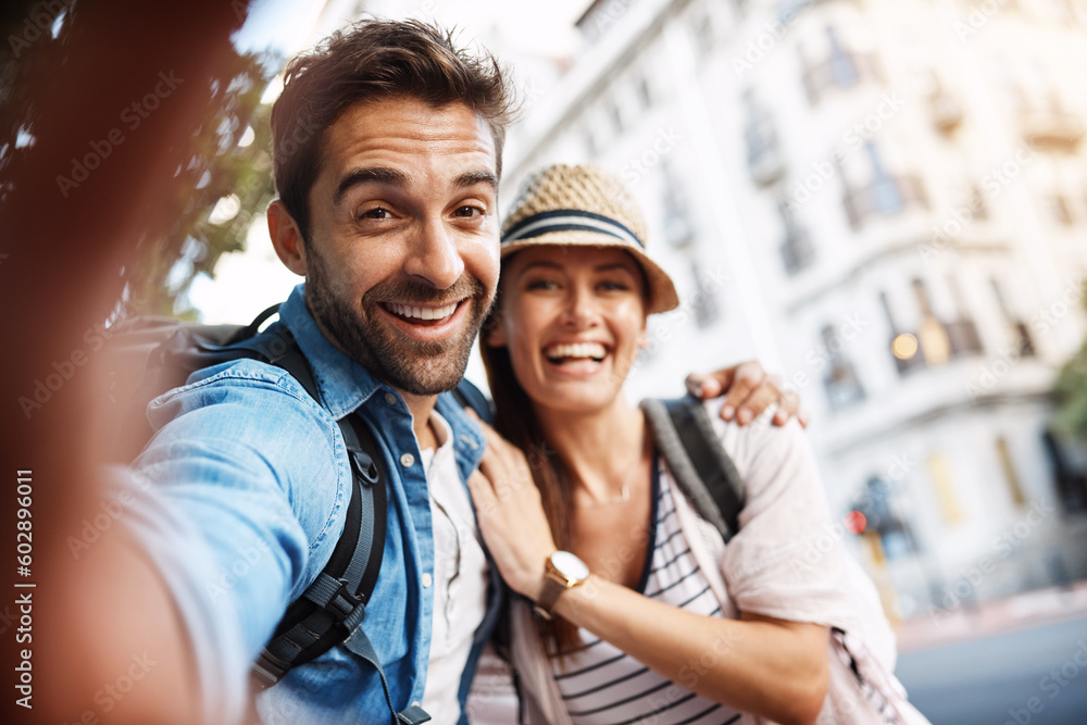 Tourist couple, happy and selfie for travel on a city street with a partner for holiday memory. Face of a man and woman outdoor on urban road for adventure, journey or vacation for freedom and relax