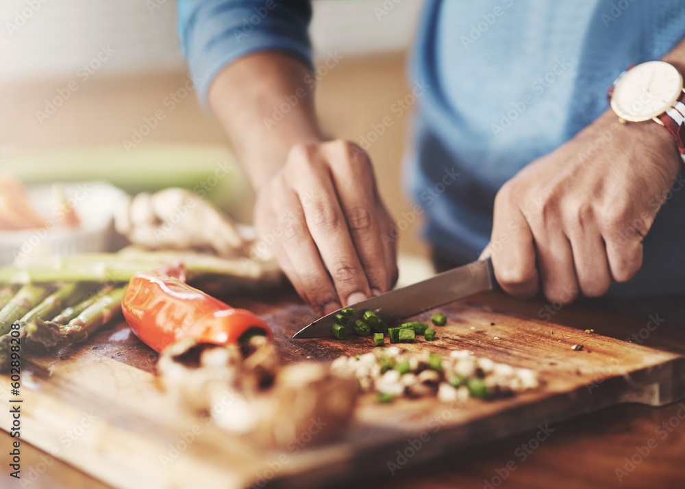 Cooking, chopping board and hands of man in kitchen for food, wellness and nutrition. Health, diet and dinner with closeup of male chef cutting vegetables with knife at home for lunch, vegan or salad