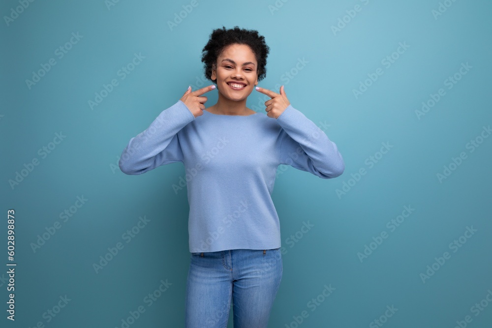 positive energetic young brunette latin lady with afro curls in stylish spring clothes on isolated background positive energetic young brunette latin lady with afro curls in stylish spring clothes on isolated background