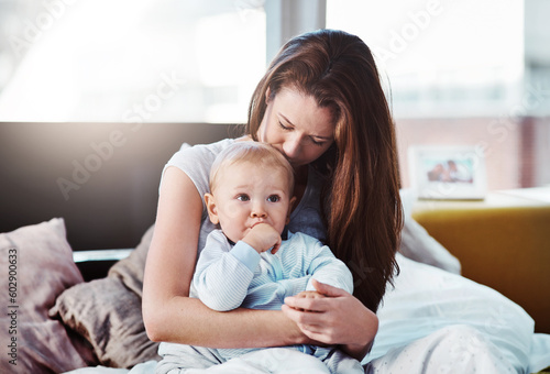 Baby, mother and hug in bed with love or bedroom, peace in morning and newborn together, relax and calm mom in home. Postpartum, boy and quality time with mama to enjoy, support or care for child
