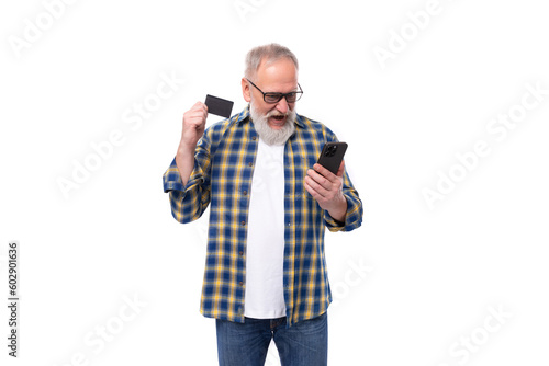 well-groomed 50s mid-aged gray-haired retired man with mustache and beard pays for online purchases