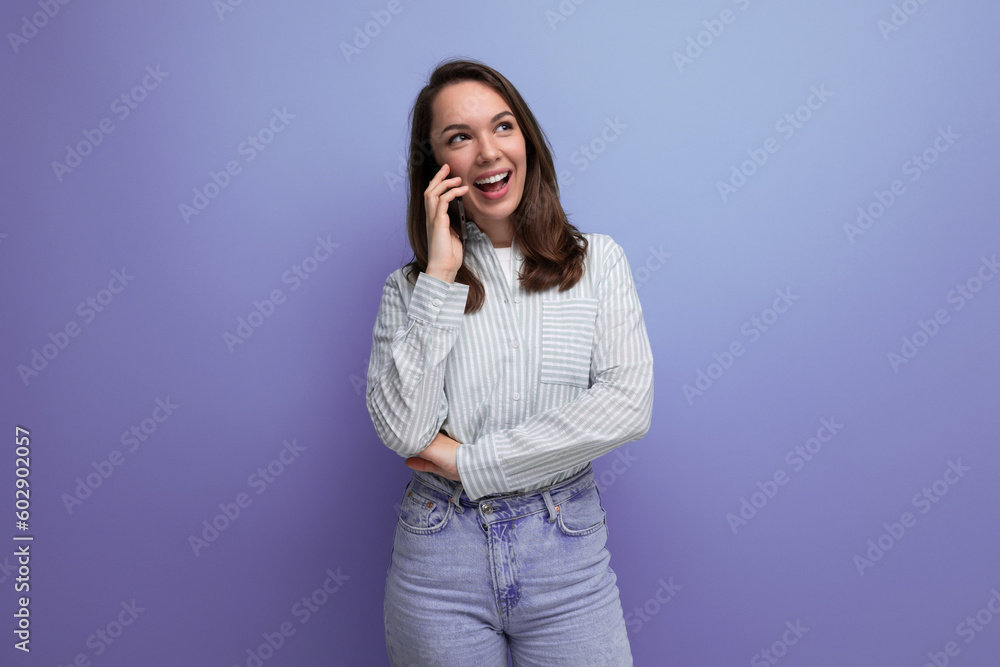 emotional slim 25s woman with dark hair in casual clothes chatting on the phone emotional slim 25s woman with dark hair in casual clothes chatting on the phone