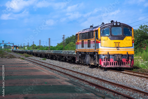Freight train by diesel locomotive on the railway in Thailand.