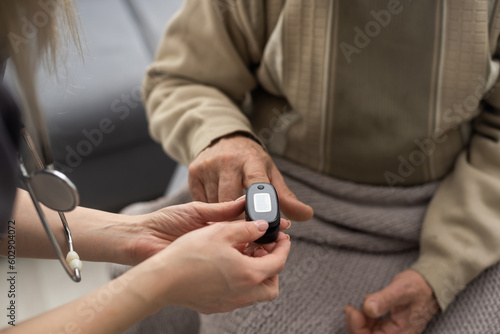 Measurement of oxygen level and pulse rate with a portable pulse oximeter - a man monitors his health