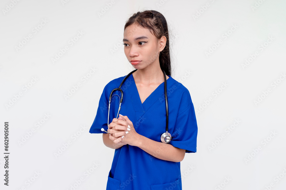 A tearful and and miserable medical student or nurse or intern apologizing with both her hands clasped together. Isolated on a white background. A tearful and and miserable medical student or nurse or intern apologizing with both her hands clasped together. Isolated on a white background.
