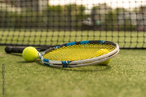 tennis racket with a tennis ball on a tennis court