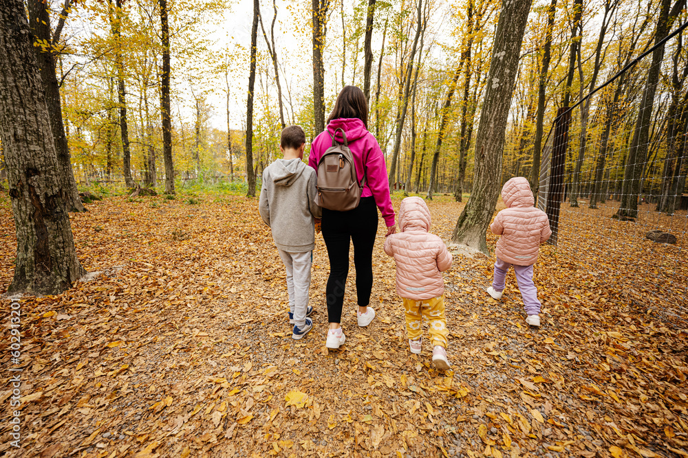 Mother with kids on a walk in autumn forest. Mother with kids on a walk in autumn forest.