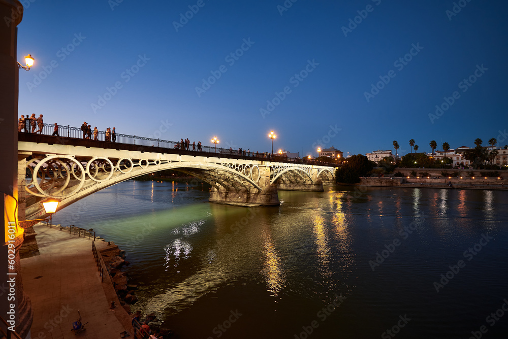 Night view of the Isabel II bridge (Triana Bridge) at Sunset, Sevilla, Spain, Europe,.