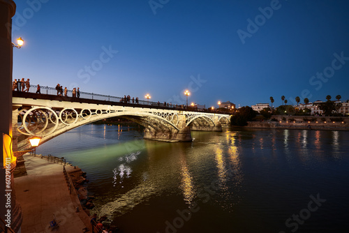 Night view of the Isabel II bridge (Triana Bridge) at Sunset, Sevilla, Spain, Europe,. © Juanma