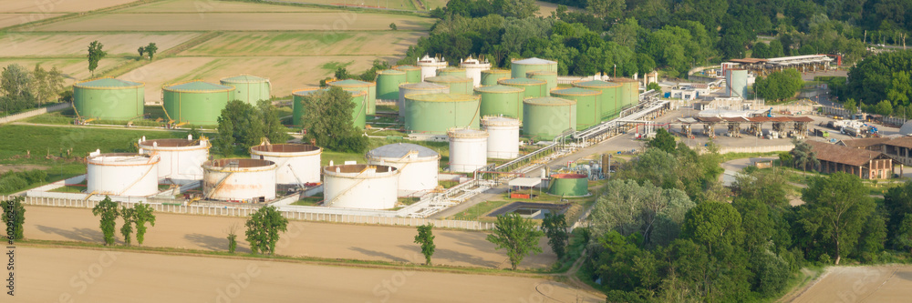 Oil refinery plant at sunny day.Ecosystem and healthy environment concepts. Lacchiarella, Italy Oil refinery plant at sunny day.Ecosystem and healthy environment concepts. Lacchiarella, Italy