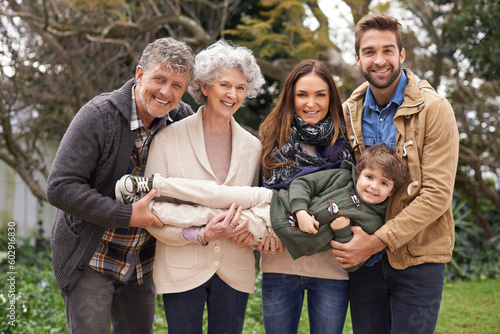 Happy family, portrait and grandparents with parents and child in a park on outdoor vacation or holiday. Face of mother, happiness and father play with kid as love, care and together in nature