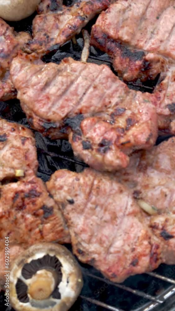 Rich Flavors Grilled Pork Steaks Cooked on Charcoal Street BBQ with vegetables. Rich Flavors Grilled Pork Steaks Cooked on Charcoal Street BBQ with vegetables.