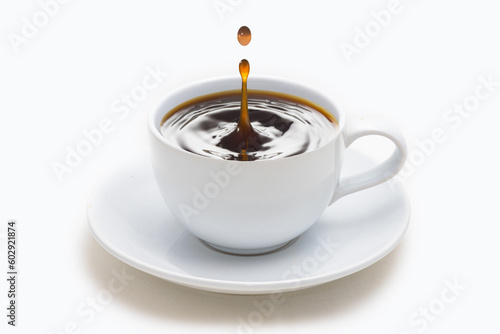 Coffee drops in white cup isolated on white background