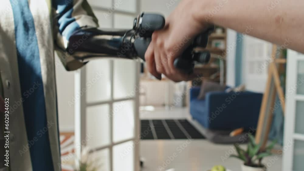 Selective focus shot of unrecognizable woman with disability using prosthetic arm to do handshake with her friend Selective focus shot of unrecognizable woman with disability using prosthetic arm to do handshake with her friend