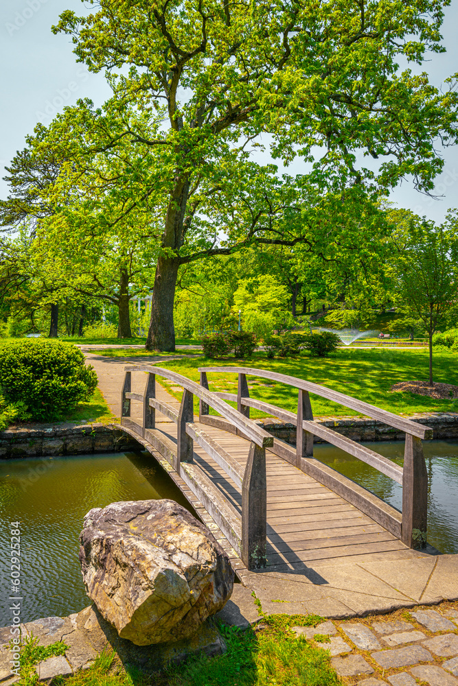 Japanese Garden at Roger Williams Park, Providence, Rhode Island, a footbridge over the pond, and green trees on the island