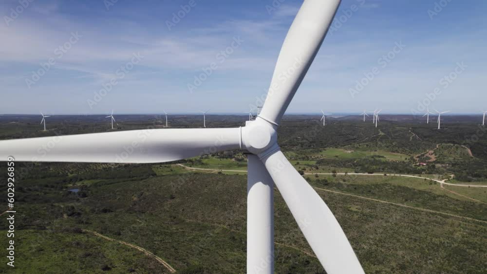 Close-up shot of Wind turbine spinning generating clean energy, Aerial view Close-up shot of Wind turbine spinning generating clean energy, Aerial view