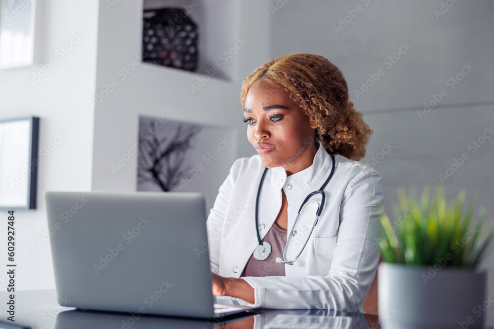 Doctor typing medical report while having online consultation with patient Doctor typing medical report while having online consultation with patient