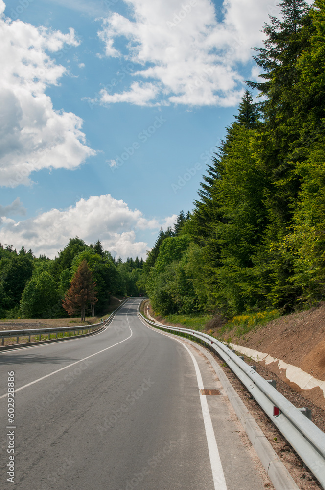 Fototapeta premium highways in the mountains against the background of the sunny sky and the white clouds