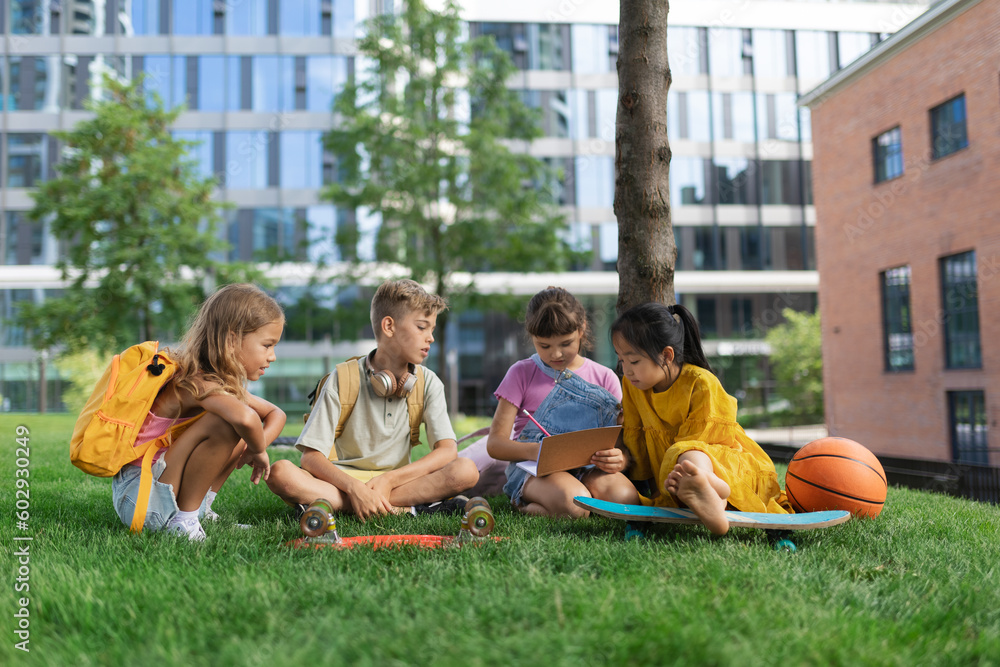 Happy kids playing and talking together in city park, during summer day. Happy kids playing and talking together in city park, during summer day.