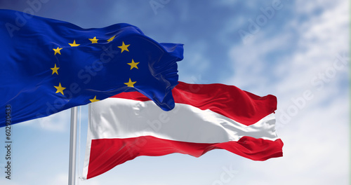 Austria and European Union flags waving together on a clear day