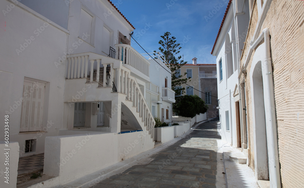 Greece, destination Andros island Chora town. Cycladic architecture, alley, sun blue sky summer day.