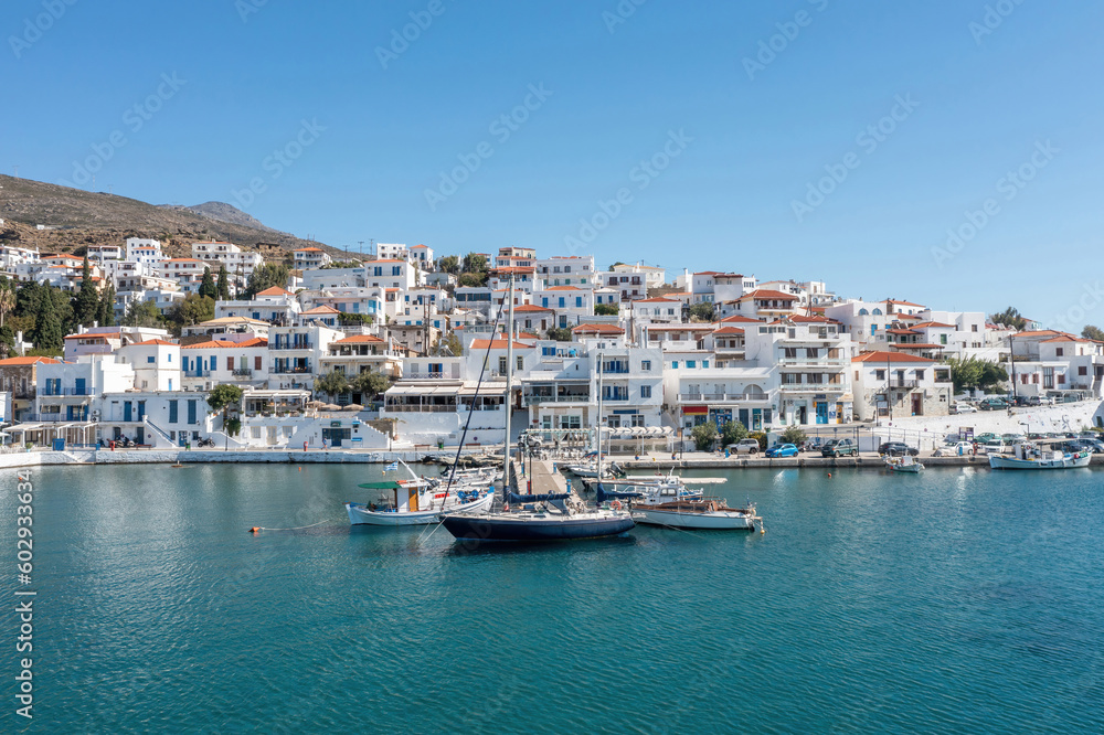 Andros island, Batsi village, Cyclades Greece. View of seafront building, cafe, port, sea, sky.