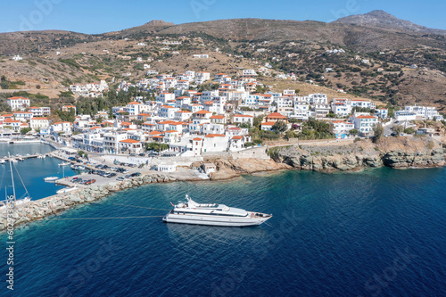 Andros island  Batsi village Cyclades Greece. Aerial drone view of building  port  yacht  sea  sky.