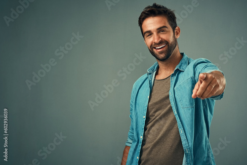 Fotografie Pointing, mockup or portrait of happy man in studio for choosing accountability, motivation or decision