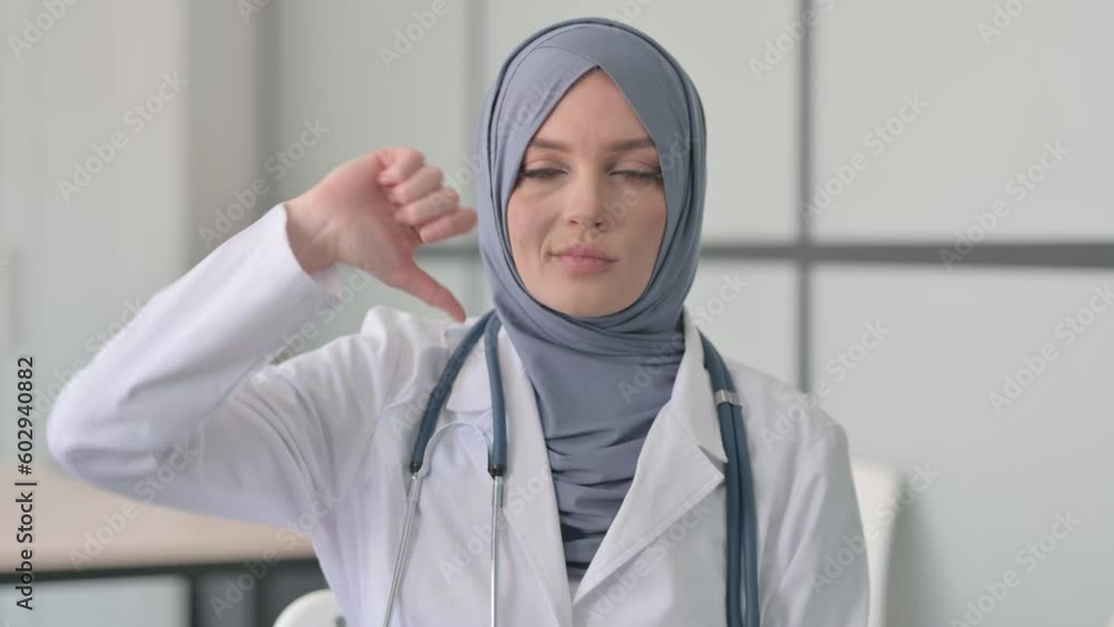 Thumbs Down by Muslim Female Doctor in Clinic Thumbs Down by Muslim Female Doctor in Clinic
