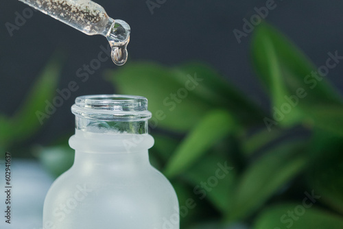 A drop of oil flows from the pipette