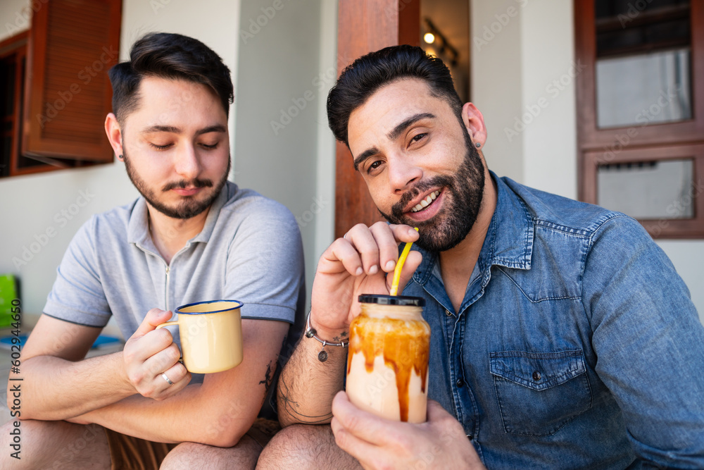 fun gay couple celebrating and drinking alcohol at home fun gay couple celebrating and drinking alcohol at home