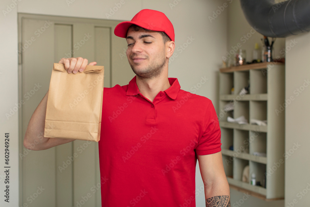young handsome man smiling and looking with a happy confident expression. delivery man concept young handsome man smiling and looking with a happy confident expression. delivery man concept