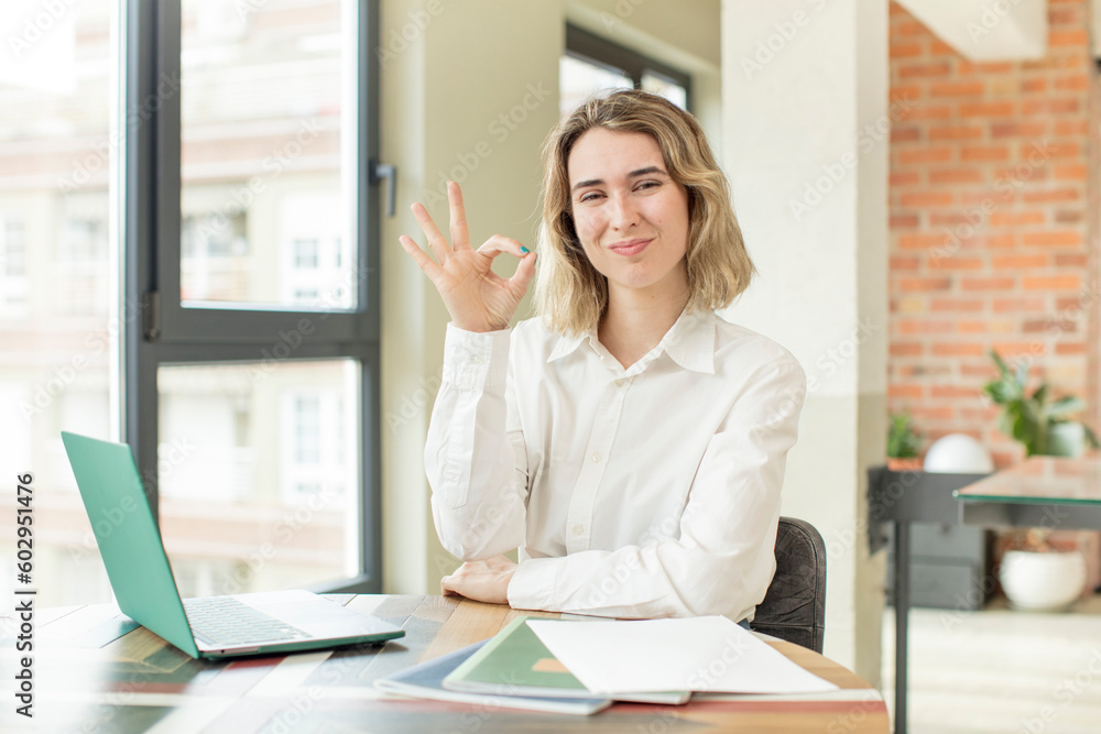 pretty woman feeling happy, showing approval with okay gesture. home work telecommuting concept pretty woman feeling happy, showing approval with okay gesture. home work telecommuting concept