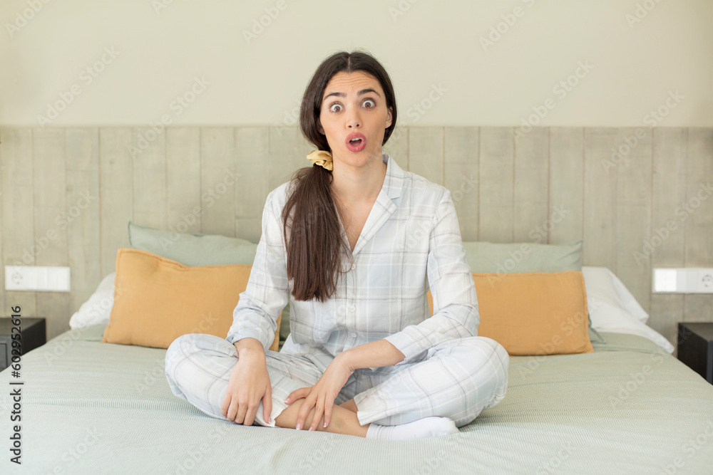 pretty young model feeling extremely shocked and surprised. rest and nightwear concept pretty young model feeling extremely shocked and surprised. rest and nightwear concept