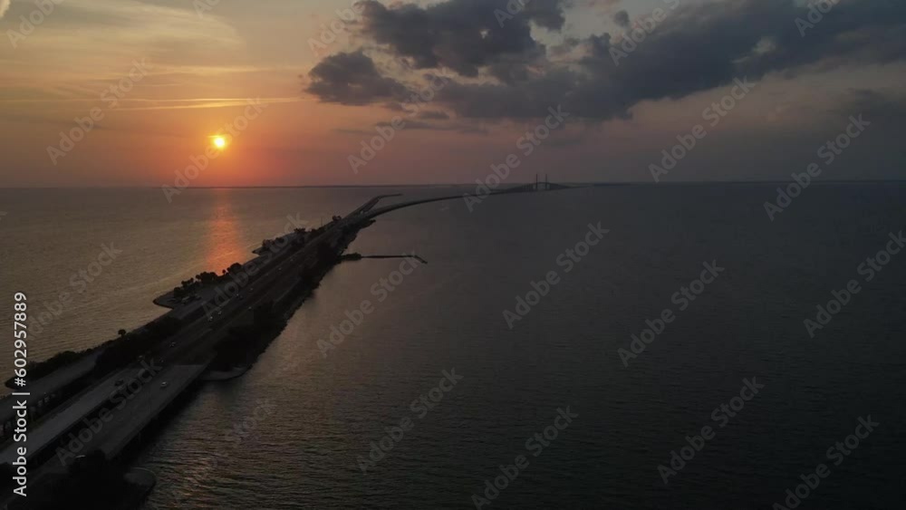 Sunshine Skyway tollway at sunset via drone. Endless expanse of water Sunshine Skyway tollway at sunset via drone. Endless expanse of water