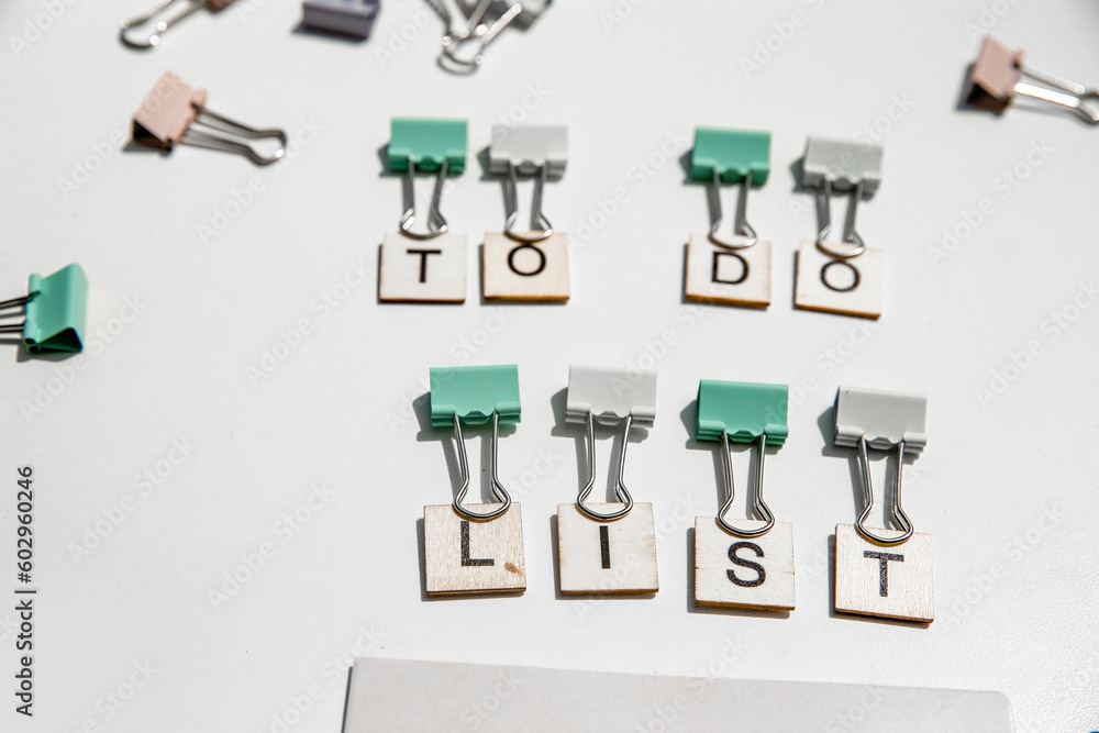 to-do list wording and metal paper clips isolated over white background, business concept, memory reminder paper, work or educational tools to-do list wording and metal paper clips isolated over white background, business concept, memory reminder paper, work or educational tools