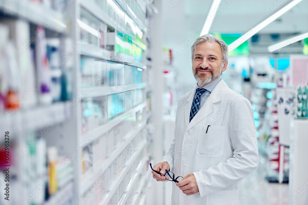 Portrait of an adult male pharmacist, posing for the camera, smiling.