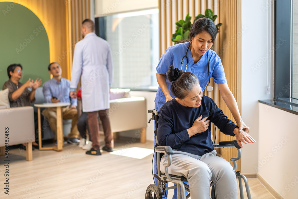 Portrait of asian woman physiotherapist carer helpphysical and discussing consulting talk with senior woman patient by doing exercises in wheelchair in rehabilitation at hospital.healthcare, medicine