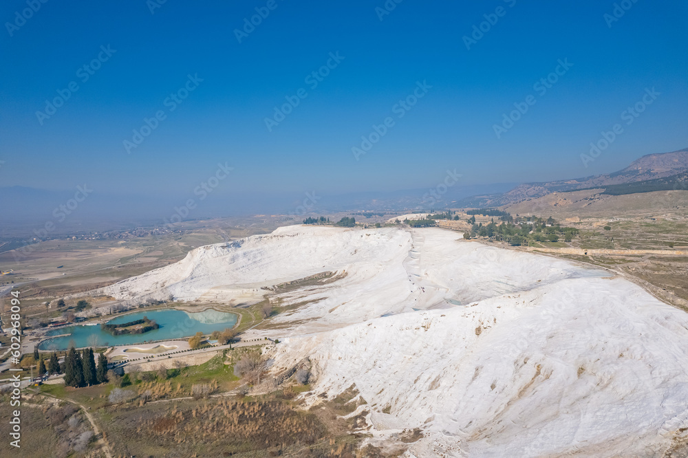 Pamukkale travertine pools, terraces with blue water, aerial top view. Concept travel landmark Turkey