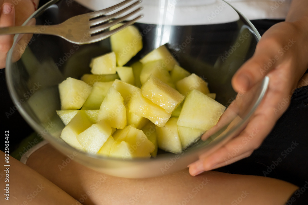 girl eat Muskmelon on the couch