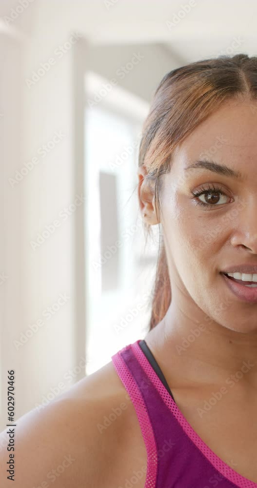 Vertical video of portrait of happy biracial sportswoman at gym in slow motion Vertical video of portrait of happy biracial sportswoman at gym in slow motion