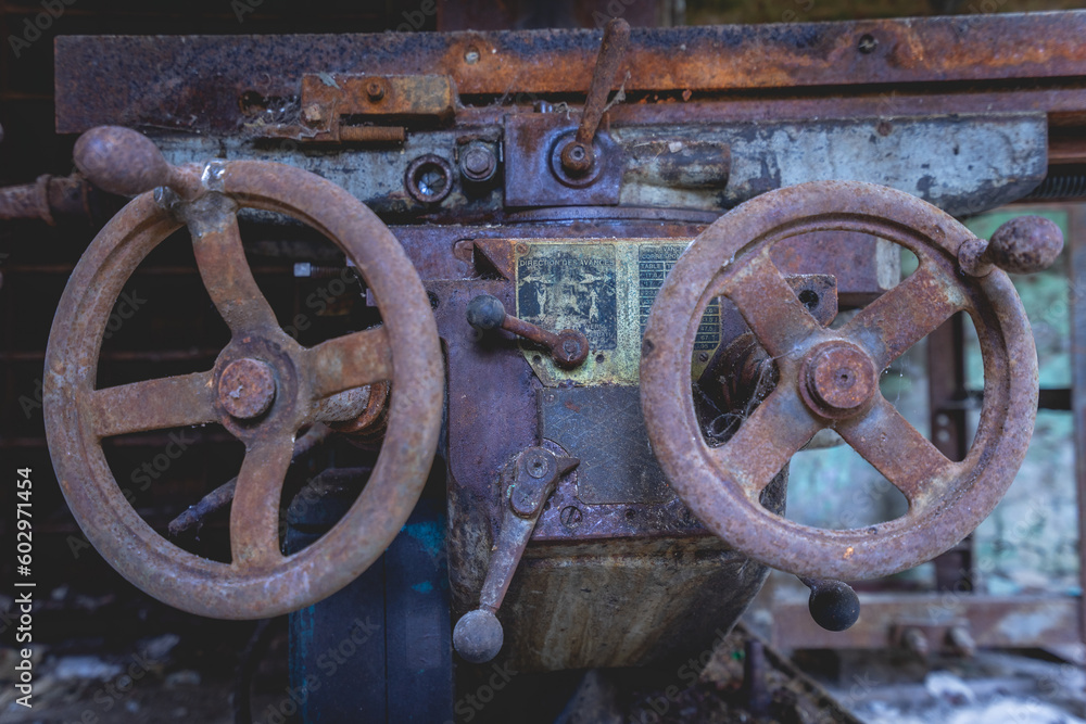 Old rusty machines in an abandoned factory.