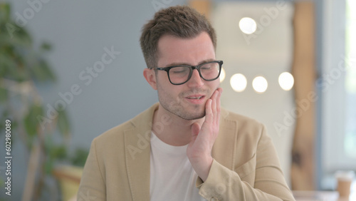 Portrait of Young Businessman with Toothache