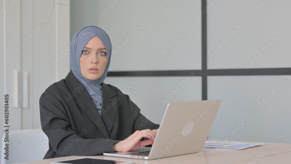 Shocked Muslim Businesswoman Working on Laptop Shocked Muslim Businesswoman Working on Laptop